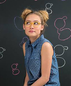 Kensie Girl Ad with blonde girl wearing yellow eyeglasses
